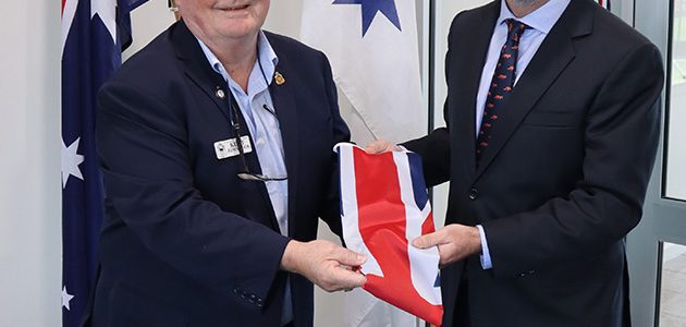 Two men in suits holding Australian flag